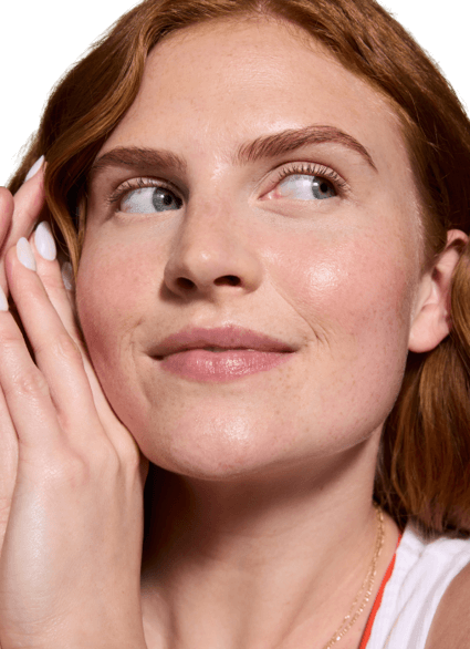 Four Curology products — Gentle Cleanser, Cream Moisturizer, Everyday Sunscreen (spf 30) and Emergency Spot Patches —  against a beige background